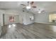 Open-concept living room with neutral walls, wood-look floors, and plenty of natural light at 5037 Bermuda Cir # 10, Orlando, FL 32808