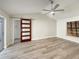 Spacious main bedroom with fan, wood floors, and sliding barn door to en-suite bathroom at 5037 Bermuda Cir # 10, Orlando, FL 32808