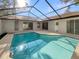 A refreshing screened-in pool area is surrounded by a spacious patio and home exterior at 5037 Bermuda Cir # 10, Orlando, FL 32808
