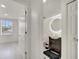 Bathroom with a dark vanity, modern round mirror and neutral flooring and walls at 5118 Luna Negra Dr, Orlando, FL 32811