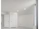 Bright bedroom featuring white walls, neutral flooring, recessed lighting, and two doors at 5118 Luna Negra Dr, Orlando, FL 32811