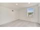 Bright bedroom featuring a window, sloped ceiling, neutral flooring, and white walls at 5118 Luna Negra Dr, Orlando, FL 32811