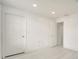 Bright bedroom featuring neutral flooring, white walls, recessed lighting, and two doors at 5118 Luna Negra Dr, Orlando, FL 32811