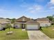 Inviting home with lush green lawn and a well-maintained exterior at 5118 Luna Negra Dr, Orlando, FL 32811