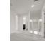 Hallway leading to a bathroom, featuring neutral flooring, recessed lighting, and white walls at 5118 Luna Negra Dr, Orlando, FL 32811