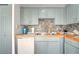 Cozy kitchen features blue cabinets, tile backsplash, and wood countertops at 5118 Luna Negra Dr, Orlando, FL 32811