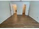 Spacious bedroom with hardwood floors, closet, and bathroom access at 5468 E Michigan E St # 4, Orlando, FL 32812