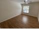 Cozy bedroom featuring laminate floors and natural light from a window at 5468 E Michigan E St # 4, Orlando, FL 32812