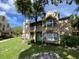 Charming multi-story townhome with balcony, green grass and ample foliage at 5468 E Michigan E St # 4, Orlando, FL 32812