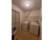 Bright laundry room with tile floors features washer, dryer, and closet storage space at 5468 E Michigan E St # 4, Orlando, FL 32812