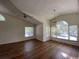 Spacious living room with vaulted ceilings and hardwood floors showcases multiple windows at 5468 E Michigan E St # 4, Orlando, FL 32812