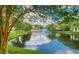 Scenic community pond view with fountain surrounded by lush greenery and buildings at 5468 E Michigan E St # 4, Orlando, FL 32812
