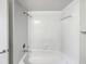Fresh bathroom featuring a shower-tub combo with white tile and neutral fixtures at 553 Floral Dr, Kissimmee, FL 34743
