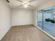 Cozy bedroom featuring neutral carpeting and a window offering ample natural light at 553 Floral Dr, Kissimmee, FL 34743