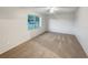 Bright, empty bedroom featuring neutral walls, carpet flooring, a ceiling fan, and a large window at 553 Floral Dr, Kissimmee, FL 34743