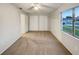 Cozy bedroom filled with natural light and featuring neutral paint and carpet flooring at 553 Floral Dr, Kissimmee, FL 34743