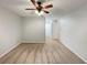 Simple carpeted bedroom with neutral walls and ceiling fan; a clean and inviting space at 553 Floral Dr, Kissimmee, FL 34743