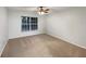 Clean bedroom featuring neutral paint, carpet flooring, and ample natural light at 553 Floral Dr, Kissimmee, FL 34743