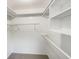 Walk-in closet with built-in shelving, offering ample storage space at 553 Floral Dr, Kissimmee, FL 34743