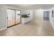Spacious living room with tile flooring, natural light, and sliding glass doors to adjacent room at 553 Floral Dr, Kissimmee, FL 34743