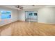 Spacious living room with tile floors, ceiling fan, and sliding glass doors to the backyard at 553 Floral Dr, Kissimmee, FL 34743