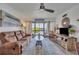 Cozy living room featuring a brown sofa, stylish decor, and sliding glass doors with a serene lake view at 574 Orange Dr # 78, Altamonte Springs, FL 32701