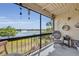 Serene screened patio offers a peaceful retreat with scenic lake views and comfortable wicker rocking chairs at 574 Orange Dr # 78, Altamonte Springs, FL 32701
