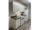 Clean kitchen featuring white appliances, dark countertops, and white shaker-style cabinets at 627 Dory Ln # 202, Altamonte Springs, FL 32714