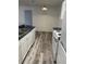 Kitchen area featuring black countertops, white cabinets and appliances, and wood-look flooring at 627 Dory Ln # 202, Altamonte Springs, FL 32714