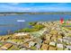 A beautiful aerial view of the community near a large lake and the clubhouse with a pool and tennis courts at 633 Watercrest Dr, Haines City, FL 33844