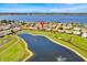 An aerial view of the neighborhood and a large lake from above with blue skies at 633 Watercrest Dr, Haines City, FL 33844