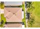 An aerial view of the roof of the property, along with some trees, golf course, and sidewalk at 633 Watercrest Dr, Haines City, FL 33844