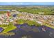 A gorgeous aerial view of this community, featuring a lake, community buildings, and a view of the surrounding nature at 633 Watercrest Dr, Haines City, FL 33844