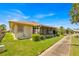 Charming home exterior featuring a well-maintained lawn and screened patio at 633 Watercrest Dr, Haines City, FL 33844