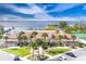 Waterfront condo featuring lush landscaping, palm trees, and manicured lawn at 633 Watercrest Dr, Haines City, FL 33844