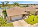 Charming single-story home boasts a brick facade, two-car garage, and a neatly paved driveway at 633 Watercrest Dr, Haines City, FL 33844