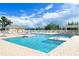 A beautiful swimming pool with multiple sections, lounge chairs, and a covered patio at 633 Watercrest Dr, Haines City, FL 33844