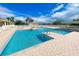 Beautiful swimming pool with many sections and lounge seating surrounded by tropical landscaping at 633 Watercrest Dr, Haines City, FL 33844