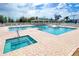 A tranquil pool and hot tub area with comfortable seating for relaxing by the water at 633 Watercrest Dr, Haines City, FL 33844