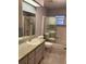 Bathroom with updated fixtures, granite countertops, shower and tub combo, and natural light at 6419 Borg St, Leesburg, FL 34748