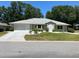 Charming single-story home featuring a well-maintained lawn, mature trees, and a two-car garage at 6419 Borg St, Leesburg, FL 34748