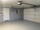 Spacious garage with painted floor and door to the main house at 6419 Borg St, Leesburg, FL 34748
