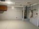 Organized garage with pegboard walls, built in storage, epoxy floors, and an updated water heater at 6419 Borg St, Leesburg, FL 34748