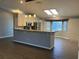 Open kitchen with granite countertops, stainless steel appliances, gray flooring and bar seating at 6419 Borg St, Leesburg, FL 34748