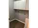 Laundry room featuring overhead cabinets and vinyl flooring at 6419 Borg St, Leesburg, FL 34748
