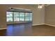 Large living room with archway and access to a screened in sunroom with views of the backyard at 6419 Borg St, Leesburg, FL 34748