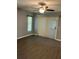 Living room with neutral walls, gray flooring, and large windows providing lots of natural light at 6419 Borg St, Leesburg, FL 34748