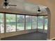Screened-in sunroom with views of the backyard and ceiling fans for added comfort at 6419 Borg St, Leesburg, FL 34748
