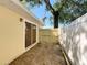 Backyard view featuring the side of the home and fencing at 6508 Coral Cove Dr, Orlando, FL 32818