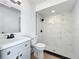 Bathroom with white vanity, marble look tile, and modern, matte black fixtures at 6508 Coral Cove Dr, Orlando, FL 32818